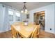 Charming dining room with hardwood floors, a wooden table with seating for six, and a stylish chandelier at 69 Folly Road Blvd, Charleston, SC 29407
