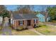 Classic brick home featuring black shutters and a brick walkway at 69 Folly Road Blvd, Charleston, SC 29407
