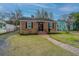 Charming brick home featuring manicured landscaping, new roof, and a walkway to the front door at 69 Folly Road Blvd, Charleston, SC 29407