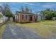 Charming single story brick home featuring a new roof, a driveway, and manicured landscape at 69 Folly Road Blvd, Charleston, SC 29407