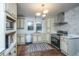 Modern kitchen featuring stainless steel appliances, custom cabinets, tiled backsplash, and stylish lighting fixtures at 69 Folly Road Blvd, Charleston, SC 29407