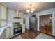 Bright kitchen featuring stainless steel appliances, cream cabinets, and a view into the dining room at 69 Folly Road Blvd, Charleston, SC 29407