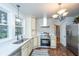 Charming kitchen with stainless steel appliances, cream cabinets, and view to outside from window at 69 Folly Road Blvd, Charleston, SC 29407