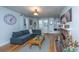 Inviting living room featuring hardwood floors, a gray couch, brick fireplace, and a bay window with a window seat at 69 Folly Road Blvd, Charleston, SC 29407