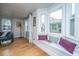 Bright living room featuring hardwood floors, comfortable seating, and a bay window with a cozy window seat at 69 Folly Road Blvd, Charleston, SC 29407