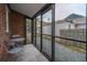Relaxing screened porch with seating area and views of the backyard at 69 Folly Road Blvd, Charleston, SC 29407
