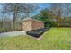 Brick shed with wooden doors, garden beds, and a gravel area at 69 Folly Road Blvd, Charleston, SC 29407