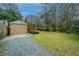 Backyard shed with wooden doors and a gravel area at 69 Folly Road Blvd, Charleston, SC 29407