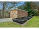 Shed features wooden doors, brick facade, and garden beds at 69 Folly Road Blvd, Charleston, SC 29407