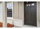 Close-up of a modern black front door with sidelight, framed by painted brick and matching trim at 981 Margaret Dr, Ladson, SC 29456