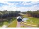 Scenic aerial view of a wooden bridge over a lake, surrounded by lush green trees and landscapes at 1004 Tulip Shell, Summerville, SC 29485