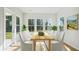 Bright dining room features large windows, a light wood table, and seating for six with neutral walls and flooring at 1004 Tulip Shell, Summerville, SC 29485