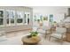 An open-concept living area with hardwood floors, a round coffee table, and a view to the dining room at 1004 Tulip Shell, Summerville, SC 29485