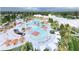 Aerial view of community pool, lounge chairs, cabanas, palm trees, and recreation area at 1004 Tulip Shell, Summerville, SC 29485