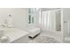 Bright bathroom featuring white tile, a vanity, a shower, and a bench at 102 Ponsbury Rd, Mount Pleasant, SC 29464