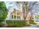 Charming two-story home with a welcoming front porch, lush landscaping, and mature trees providing shade and curb appeal at 102 Ponsbury Rd, Mount Pleasant, SC 29464