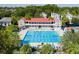 Aerial view of a community pool featuring swimming lanes and lounge area with seating, surrounded by trees and neighborhood buildings at 102 Ponsbury Rd, Mount Pleasant, SC 29464