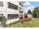 Exterior of a condo featuring screened balconies, a well-maintained lawn, and landscaped garden beds at 1025 Riverland Woods Pl # 314, Charleston, SC 29412