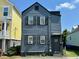 Charming two-story home with a dark blue exterior and traditional shutters adding to the curb appeal at 103 Cooper St, Charleston, SC 29403