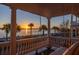 Picturesque balcony view showcases a waterfront sunrise with palm trees and a swing at 104 Murray Blvd, Charleston, SC 29401