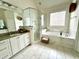 Gorgeous bathroom with a glass shower, soaking tub, granite countertops and white cabinets at 108 Bateaux Dr, Summerville, SC 29483