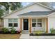 Inviting front porch with a cozy bench, decorative welcome sign, and attractive landscaping at 115 Ridge Rd, Summerville, SC 29485