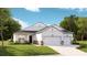 Charming single-story home featuring a three-car garage, stone accents, and a welcoming front porch at 1154 Darling St, Summerville, SC 29485