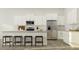 Modern kitchen with white cabinets, stainless steel appliances, a stylish breakfast bar, and wood flooring at 1154 Darling St, Summerville, SC 29485