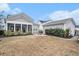 View of the backyard featuring a screened porch, detached garage, and circular fire pit at 119 Philips Park St, Summerville, SC 29486