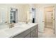 Bright bathroom featuring a double vanity, quartz countertop, and tiled shower at 119 Philips Park St, Summerville, SC 29486