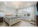 Bright bedroom with large windows, a queen-sized bed, and hardwood floors at 119 Philips Park St, Summerville, SC 29486