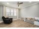 A cozy bedroom with a ceiling fan, a relaxing armchair, and wood-look floors at 119 Philips Park St, Summerville, SC 29486