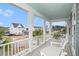 Covered porch with white columns overlooking a manicured street at 119 Philips Park St, Summerville, SC 29486