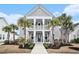 Charming two-story home with a welcoming porch, swing, and lush landscaping at 119 Philips Park St, Summerville, SC 29486