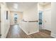 Bright hallway with wood floors, white banister, and access to outdoor balcony at 119 Philips Park St, Summerville, SC 29486