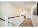 Bright hallway with hardwood floors, white railing, and natural light at 119 Philips Park St, Summerville, SC 29486