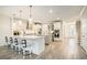 Spacious kitchen with white cabinets, granite counters, stainless appliances, and island with bar seating at 119 Philips Park St, Summerville, SC 29486
