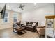 Inviting living room with a large leather couch, shiplap accent wall, and movie decor at 119 Philips Park St, Summerville, SC 29486