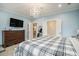 Spacious main bedroom featuring light blue walls, dresser, modern light fixture, and ensuite bathroom and closet entries at 119 Philips Park St, Summerville, SC 29486