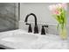 Close up of the bathroom sink area with white marble countertop and floral accents at 121 Shipyard Rd, Mount Pleasant, SC 29464