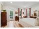 Bright main bedroom with hardwood floors, and a door leading to a private balcony at 121 W Shipyard Rd, Mount Pleasant, SC 29464