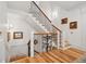 Elegant staircase featuring hardwood steps, decorative iron railing, and bright white trim at 121 W Shipyard Rd, Mount Pleasant, SC 29464