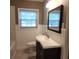 Bathroom with wainscoting, a modern vanity with a sleek countertop, and a large framed mirror at 1216 Eastwood Ave, Hanahan, SC 29410