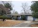 Charming single-story blue home featuring a well-manicured lawn, a driveway and an attached single-car garage at 1216 Eastwood Ave, Hanahan, SC 29410