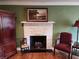 Close up on the living room brick fireplace with mantel and hearth, with decorative furniture and hardwood floors at 1216 Eastwood Ave, Hanahan, SC 29410