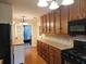 Functional kitchen featuring wood cabinets, tiled countertops and backsplash, hardwood floors, and modern appliances at 1216 Eastwood Ave, Hanahan, SC 29410