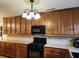 Well-lit kitchen with hardwood floors, offering wood cabinets, tile countertops/backsplash, and modern appliances at 1216 Eastwood Ave, Hanahan, SC 29410