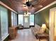 Bright sun room with a ceiling fan, multiple windows, tiled floor, and furnishings at 1216 Eastwood Ave, Hanahan, SC 29410