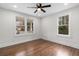 Bright bedroom with hardwood floors, ceiling fan and two windows offering plenty of light at 1226 Pickens St, Hanahan, SC 29410