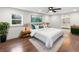 Well-lit bedroom showcasing hardwood floors, neutral decor, and ensuite bathroom at 1226 Pickens St, Hanahan, SC 29410